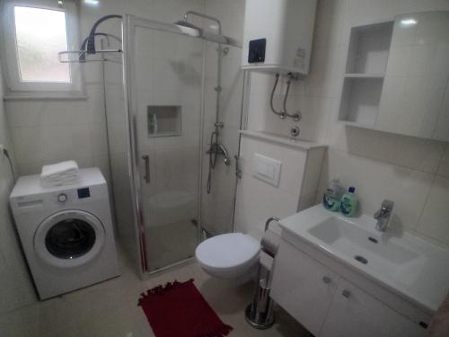 a bathroom with a shower and a toilet and a sink at Villa Green in Mostar