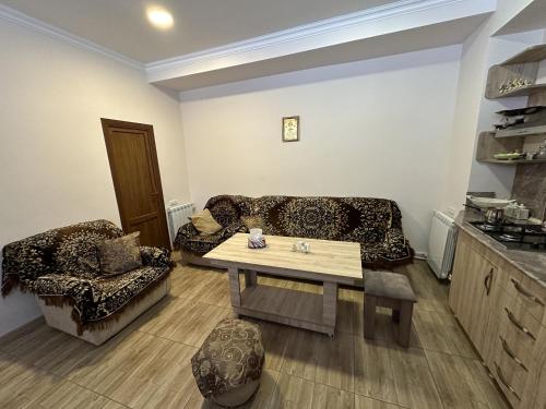 a living room with a couch and a table at Jermuk Mini Apartment in Jermuk