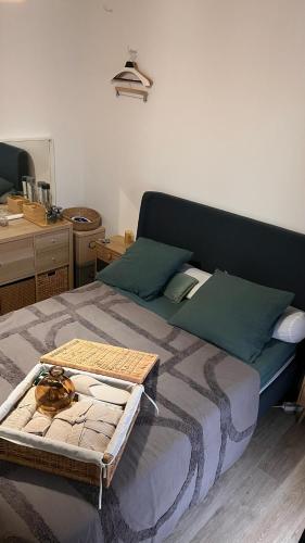 a bedroom with a bed with a tray on it at Duplex de la Gare, Grande Terrasse, Jacuzzi in Corbeil-Essonnes