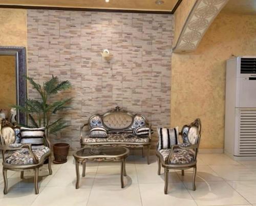 a living room with a couch and two chairs at فيلا بالعلا in AlUla