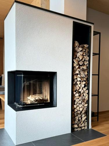 a fireplace with a pile of fire wood at Chalet Bergfuchs in Anterselva di Mezzo