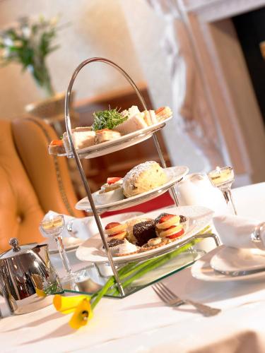 a three tiered plate of food on a table at Bridge House Hotel, Leisure Club & Spa in Tullamore