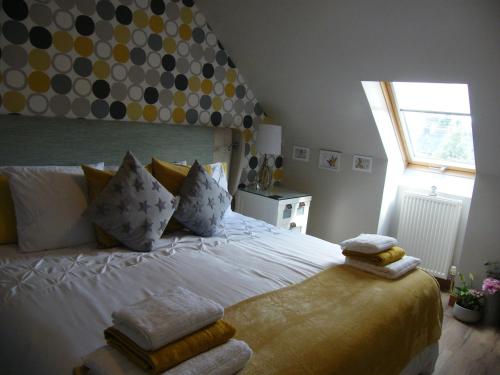 a bedroom with a bed with towels on it at Kirkside in Auchterarder