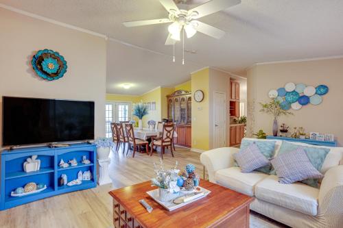 a living room with a couch and a tv at Lake Livingston Home with Dock and Deck! in Huntsville