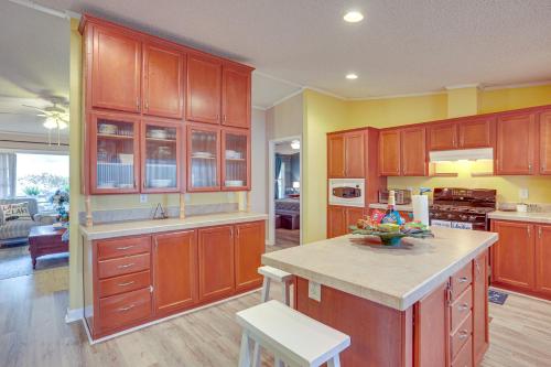 a large kitchen with wooden cabinets and a counter top at Lake Livingston Home with Dock and Deck! in Huntsville
