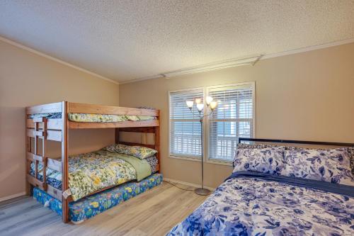 a bedroom with two bunk beds and a window at Lake Livingston Home with Dock and Deck! in Huntsville