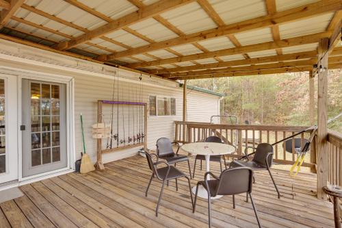 a patio with a table and chairs on a deck at Lake Livingston Home with Dock and Deck! in Huntsville