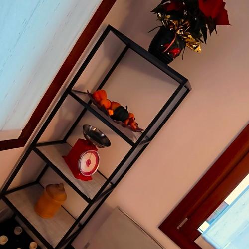 a glass shelf on a wall with a candle at Ex Casa degli Artisti in Montebelluna