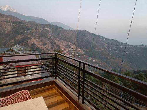 a balcony with a view of a mountain at Hotel King Castle Central Heated & Air cooled in Dharamshala