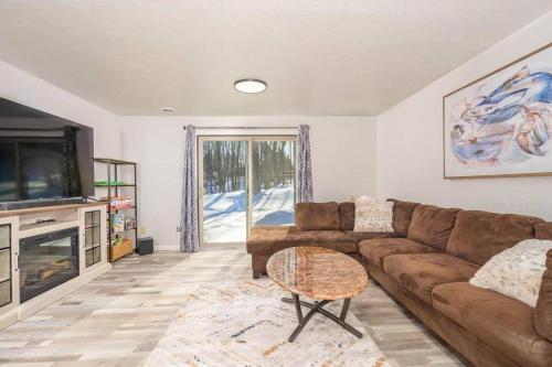a living room with a brown couch and a tv at Green Bay Cozy home, 3 bed rooms, 6 beds, 2 bath in Green Bay