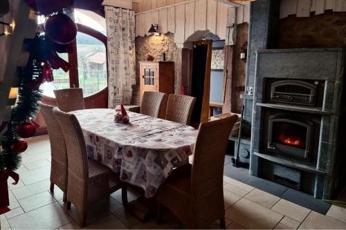 una sala da pranzo con tavolo e camino di Le Stadl Vosges a Jussarupt