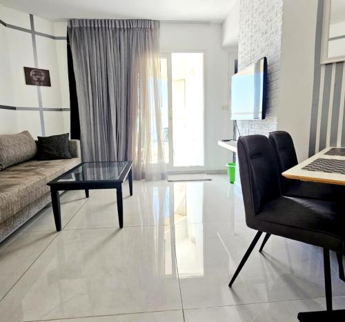a living room with a couch and a glass table at GO to apartments in Leonardo in Bat Yam