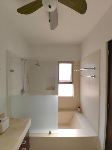 a bathroom with a ceiling fan and a shower at Casa Serena in Cancún