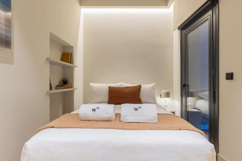 a bedroom with a white bed with two pillows at Rio by Wynwood House in Madrid