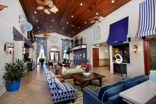 a lobby with blue chairs and a living room at Perfect Disney Holiday! Private Pool, Spa, Resort! in Kissimmee