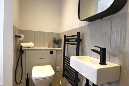a bathroom with a sink and a toilet at Kist Accommodates presents - Hygge House, Parking, EV Point in Ripon