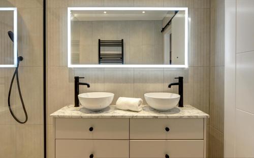 a bathroom with two sinks and a mirror at Kist Accommodates presents - Hygge House, Parking, EV Point in Ripon
