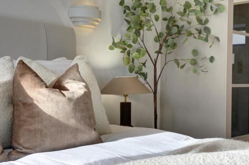 a bedroom with a bed with a pillow and a tree at Kist Accommodates presents - Hygge House in Ripon