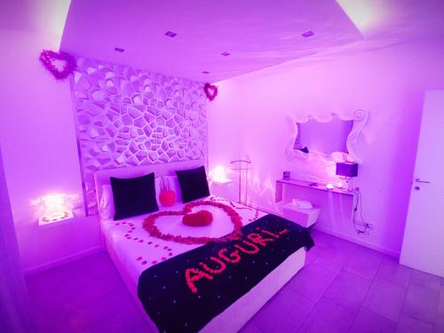 a pink bedroom with a large bed with a flower arrangement on it at Diamond Suite Verona in Verona