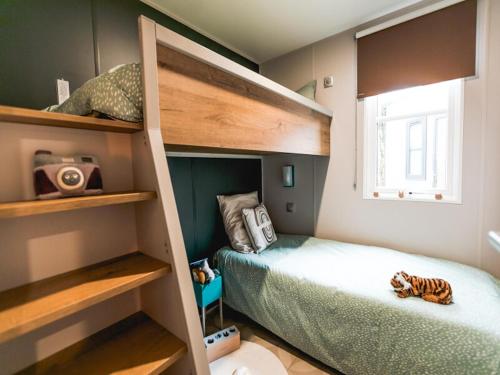 1 dormitorio pequeño con literas y 1 cama en Wadden Lodge Living, en Westerland