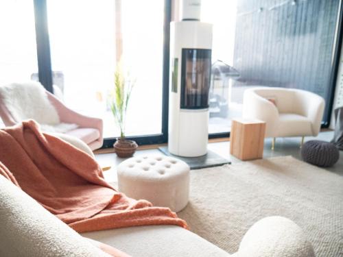 a living room with a blanket on a couch at Sunrise View Lapland, Sky View Bedroom & Hot Tub in Kilpisjärvi