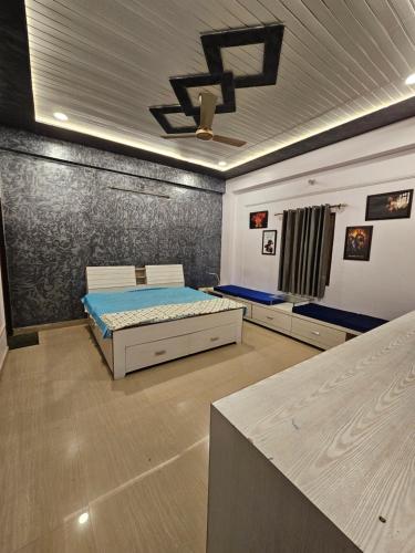 a bedroom with a bed and a wall at Sunlit stays-Forest view in Lucknow