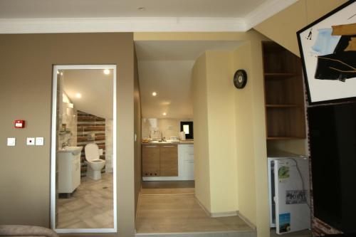 a hallway leading to a kitchen with a mirror at Apartments Panorama in Veliko Tŭrnovo