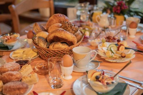 a table topped with a basket of bread and pastries at Gasthof und Pension Hammerschänke in Wildenthal