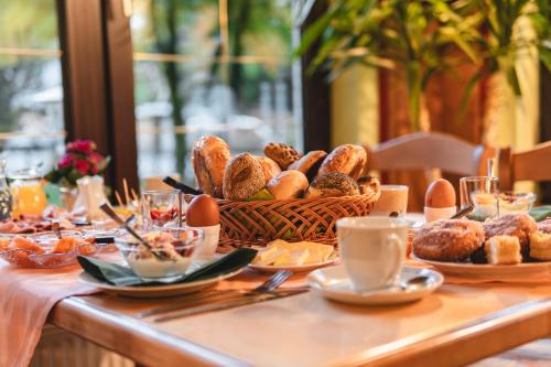 a table topped with a basket of bread and pastries at Gasthof und Pension Hammerschänke in Wildenthal