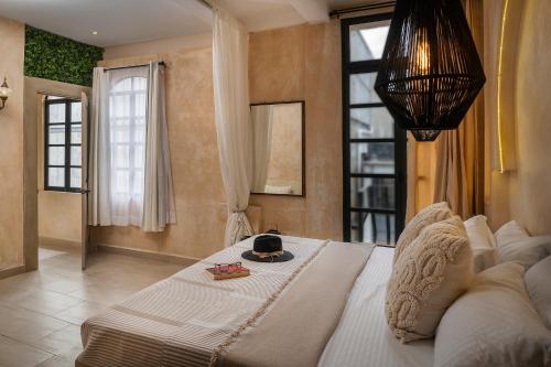 a bedroom with a large bed with a hat on it at Breathtaking PH 5thAV ocean view private pool roof in Playa del Carmen