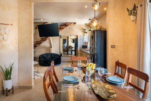 a dining room with a wooden table and chairs at Breathtaking PH 5thAV ocean view private pool roof in Playa del Carmen