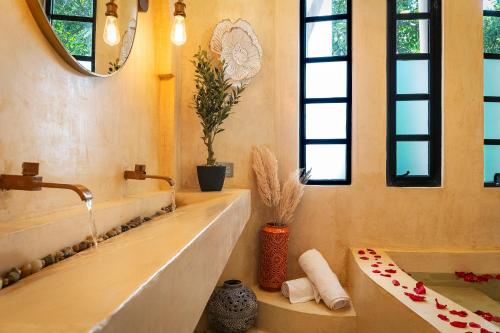 a bathroom with a bath tub and a sink at Breathtaking PH 5thAV ocean view private pool roof in Playa del Carmen