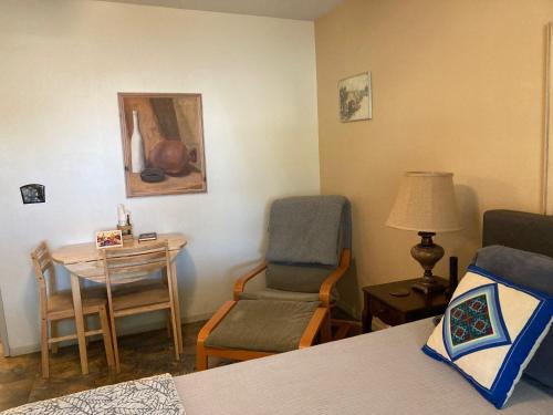 Habitación con cama, silla y mesa. en Desert retreat close to downtown/ U of A, 1-10 en Tucson