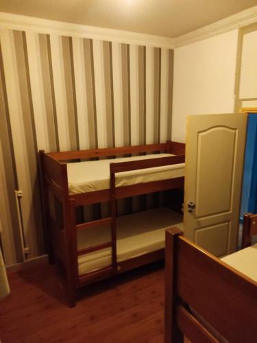 a small room with two bunk beds in it at Meeting Hostel in Figueira da Foz