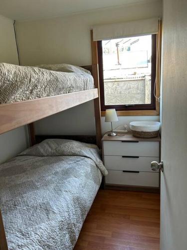a bedroom with two bunk beds and a window at Cabaña en Malalcahuello in Malalcahuello