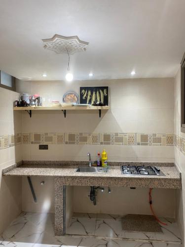 a kitchen with a sink and a counter top at Apartement au Bord de la Mer TOURMA in Taghazout