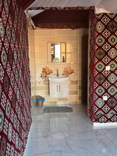 a bathroom with a sink and a mirror at Wadi rum Golden land camp in Wadi Rum
