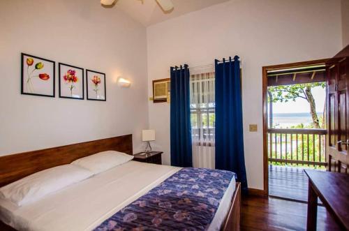 a bedroom with a bed and a view of the ocean at Pirate's den Den Hotel in Sandy Bay