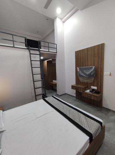 a bedroom with a bunk bed and a ladder at HOTEL SHREE RAM in Rājpīpla