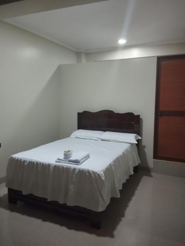 a bedroom with a bed with a tray on it at Hotel Amazon deluxe in Jaén