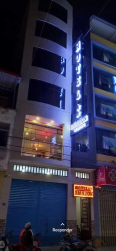 a building with a sign on the side of it at Hotel Amazon deluxe in Jaén