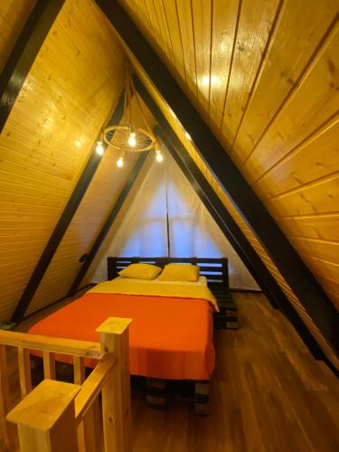 a bed in a room in a attic at Ashla A-Frame Lenkaran in Lankaran