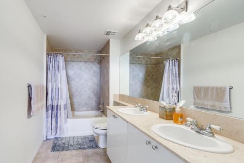 a bathroom with two sinks and a toilet at Lantana Condo with Smart TV 11 Mi to Palm Beach! in Lantana