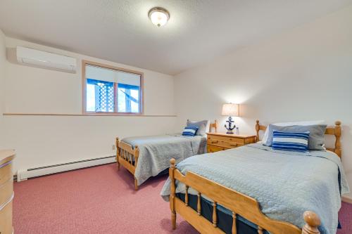 a bedroom with two beds and a window at Pet-Friendly Michigan Home with Deck and Views! in Harbor Springs