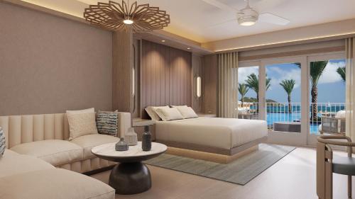 uma sala de estar com uma cama e um sofá em JW Marriott St Maarten Beach Resort & Spa em Dawn Beach