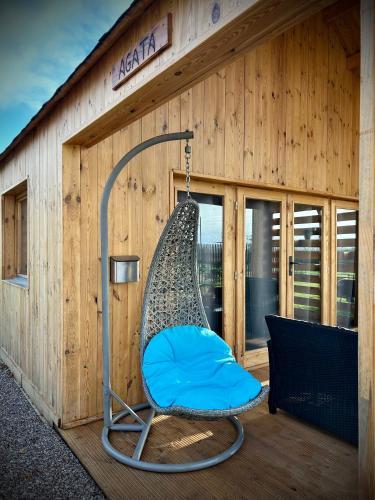 a hammock in the front of a building at Les Chalets du Parc in Saint-Eulien
