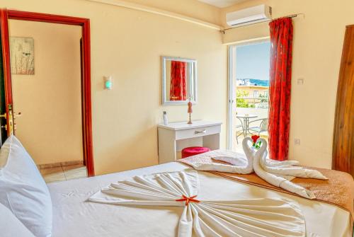 a bedroom with a bed with two swans on it at Aroma of the Sea in Kissamos