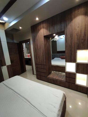 a bedroom with a bed and a large mirror at Stay daily Inn in Varanasi