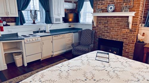 a kitchen with a table and a stove and a fireplace at Christopher Dodge House in Providence