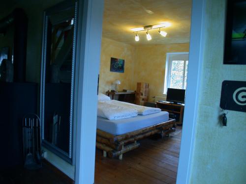 a bedroom with a bed in a room with a mirror at Erholen und Wohlfühlen Auf dem Knick in Detmold